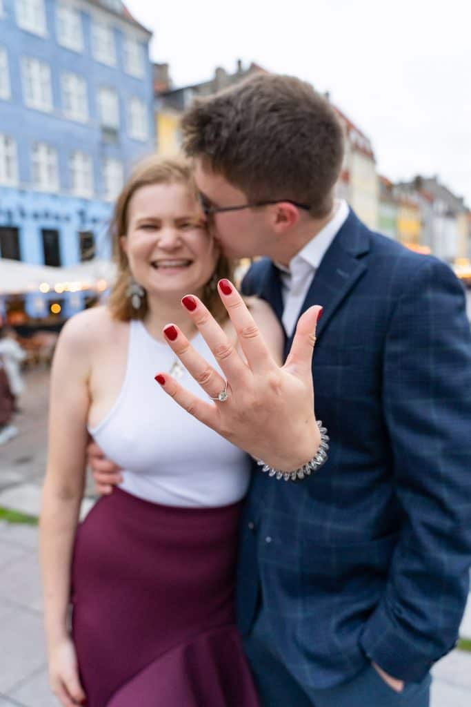 couple-showing-engagement-ring-nyhavn-copenhagen